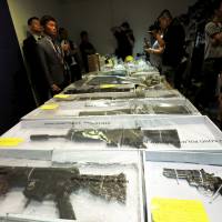 Air rifles seized along with explosives are displayed during a news conference at police headquarters in Hong Kong on Monday. | REUTERS