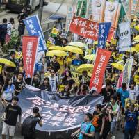 Protesters hold a pro-democracy march in Hong Kong on Sunday. BloombergProtesters hold a pro-democracy march in Hong Kong on Sunday. | BLOOMBERG