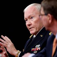Joint Chiefs Chairman Gen. Martin Dempsey, accompanied by Defense Secretary Ash Carter, speaks during an April news conference at the Pentagon. Dempsey says the new U.S. military hub could be a model for even more such training facilities — and more U.S. troops — to help the Iraqis reverse major battlefield losses to the Islamic State. Top general says U.S. looking to build more bases in Iraq in fight against Islamic State