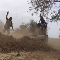 Free Syrian Army fighters fire from a tank during what they said was an offensive against the forces of Syria\'s President Bashar Assad in the southern city of Deraa, Syria, Thursday. | REUTERS