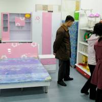 North Koreans shop at Kwangbok department store in central Pyongyang in March 2014. | REUTERS / HANDOUT VIA REUTERS