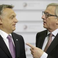 European Commission President Jean-Claude Juncker (right) speaks to Hungarian Prime Minister Viktor Orban before the Eastern Partnership Summit session in the Latvian capital of Riga on May 22. | REUTERS
