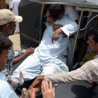 A Pakistani heatstroke victim is moved to a hospital in Karachi on Tuesday. | AFP-JIJI
