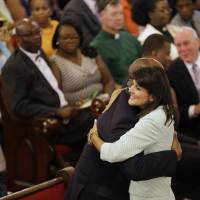 Republican South Carolina Gov. Nikki Hale embraces U.S. Sen Tim Scott at the Emanuel A.M.E. Church on Sunday, four days after a mass shooting that claimed the lives of the Rev. Clementa Pinckney and eight others in Charleston. Haley was expected Monday to demand that the Confederate flag no longer fly at the state capitol. | AP