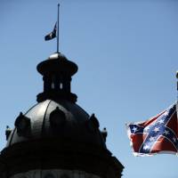 A Confederate flag flies near the South Carolina Statehouse in Columbia on June 19. Whether South Carolina should continue to fly the Confederate flag on its statehouse grounds is the latest in a series of issues to arise this summer challenging the GOP\'s effort to build the young and diverse coalition of voters it likely needs to win the White House. The flag few at full staff while the rest of the capitol\'s flags were at half-staff in connection with the church shooting massacre the previous day in Charleston. | AP