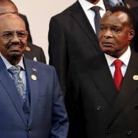 The president of the Republic of the Congo, Denis Sassou Nguesso (right), looks at Sudan\'s President Omar al-Bashir as they pose for photographers ahead of the African Union summit in Johannesburg on Sunday. | REUTERS