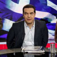 Alexis Tsipras, Greece\'s prime minister,  takes his seat for a televised interview inside a studio of Greek state television broadcaster ERT in Athens on Monday. Tsipras said European leaders don\'t have the nerve to throw his country out of the euro, striking a defiant tone just hours after imposing capital controls on a country in economic freefall. | BLOOMBERG