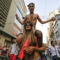 LGBT rights activists march in the main shopping and pedestrian street of Istiklal during a Gay Pride Parade in central Istanbul, Turkey, Sunday. | REUTERS