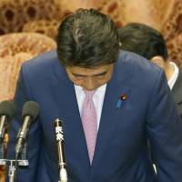 Prime Minister Shinzo Abe apologizes Monday for jeering an opposition lawmaker during a Diet session last week. | KYODO