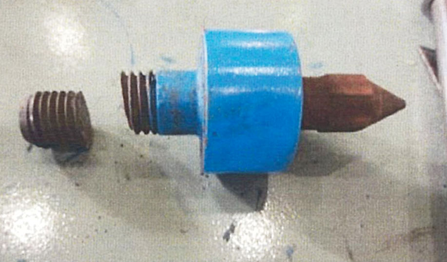 One of the bolts used to secure the lid of a container used to transport low-level radioactive waste is shown sheared at the threads. | NUCLEAR FUEL TRANSPORT CO.