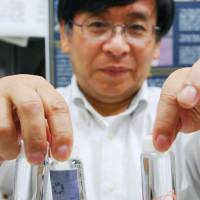 Makoto Nakamura of Toyama University shows samples of threads made from human cells at his lab in the city of Toyama on June 2. | KYODO