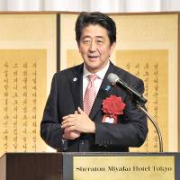 Prime Minister Shinzo Abe speaks at the Sheraton Miyako Hotel Tokyo during an event Monday marking the 50th anniversary of the normalization of diplomatic ties between Japan and South Korea. | YOSHIAKI MIURA
