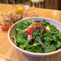 Fragrant: Coriander leaves adorn a spicy bun noodle dish. | ROBBIE SWINNERTON