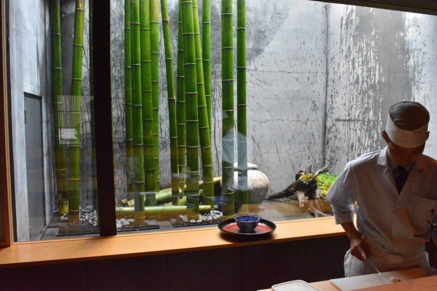 Rakushin Watching time go by: A young apprentice at Rakushin prepares a dish in front of the seasonal window display. | J.J. O'DONOGHUE
