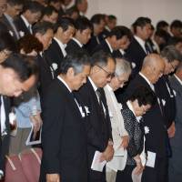 Niigata Minamata victims observe a minute’s silence on May 31 during a memorial event to mark the 50th anniversary of the disease. | ROB GILHOOLY