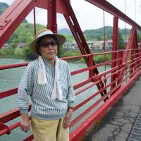 Fumiko Hatano, 79, stands on a bridge that spans the Agano River at Kanose in Niigata Prefecture on May 31. | ROB GILHOOLY