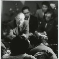 Tomoko Uemura is held by her mother as Minamata victims and their families meet the chief of the Environment Agency in 1972. Aileen M. Smith and her husband, Eugene, documented the Minamata outbreaks in Kyushu and Niigata in the 1970s. | W. EUGENE SMITH AND AILEEN M. SMITH