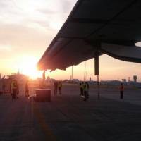 The long, lightweight wings of the Solar Impulse 2 are tied down after the aircraft\'s arrival at Nagoya Airport on June 1 in this handout photo supplied by the project team. The plane can be damaged by wind while it is on the ground and unprotected from the elements. | SOLAR IMPULSE