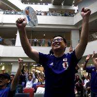 Japan\'s soccer fans celebrate their victory over England at FIFA Women\'s World Cup semi-final soccer match, at a public viewing event in Tokyo on July 2. | REUTERS