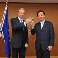Ambassador of the European Union Viorel Isticioaia-Budura (left), shares a toast with Kenji Kosaka, chairman of Japan-EU Parliamentary League of Friendship, and member of the House of Councillors during a reception to celebrate ‘‘Europe Day’’ at the Delegation of the European Union Europa House in Tokyo on May 12. | YOSHIAKI MIURA