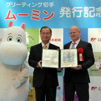 Finland Ambassador Manu Virtamo (right) receives Moomin Postage Stamps from Japan Post Co. President and CEO Toru Takahashi (center), during an event celebrating the issue of Moomin Postage Stamps | YOSHIAKI MIURA