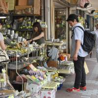People shop for kitchenware at a shopping mall in Tokyo on Friday. Japanese inflation was tepid last month, official data showed on Friday. | AFP-JIJI