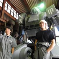 Kogoro Kurata (right) poses with the Kuratas robot in Yamanashi Prefecture in September 2012. | KAZUAKI NAGATA