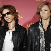 Looking good: X Japan drummer Yoshiki poses with his wax figure (right) at the opening of Madame Tussaud\'s in Tokyo in May 2013. The musician announced Saturday that X Japan will release its first album in 20 years on March 11, 2016. | AP