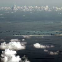 This aerial file photo taken May 11, 2015 from a military plane shows China’s alleged ongoing reclamation of Mischief Reef in the Spratly Islands in the South China Sea. Beijing says ties with Manila can flourish despite sea feud
