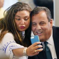 Kate Fallas takes a picture with Republican presidential candidate New Jersey Gov. Chris Christie before he spoke to a group sponsored by Americans for Peace Prosperity and Security, Wednesday in Manchester, New Hampshire. | AP