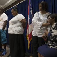 Audrey DuBose is comforted by her daughter, Terina Allen, during a news conference after murder and manslaughter charges against University of Cincinnati police officer Ray Tensing were announced for the traffic stop shooting death of her son, Samuel DuBose, Wednesday in Cincinnati. | AP
