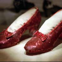This 1996 file photo shows one of the four pairs of ruby slippers worn by Judy Garland in the 1939 film \"The Wizard of Oz\" on display during a media tour of the \"America\'s Smithsonian\" traveling exhibition in Kansas City, Missouri. An anonymous donor has offered a $1 million reward for credible information leading to a pair of the sequined shoes that were stolen from a museum in her Minnesota hometown, Grand Rapids. The 10-year anniversary of the theft is in August. | AP