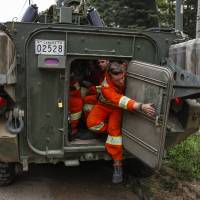 Members of the Canadian Forces prepare to head out to look for hotspots from wildfires near Montreal Lake, Saskatchewan, Thursday. Large wildfires raging across Canada have contributed to a smoky haze lingering above the Western U.S., blazes fueled by the familiar hot, and dry conditions that have turned much of the region into a tinderbox. Canada looks far afield for help with wildfires; blazes' haze spreads across many U.S. states