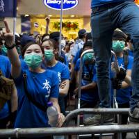 Anti-Beijing demonstrators shout at a pro-China group in Hong Kong\'s Mong Kok shopping district on July 11. | REUTERS
