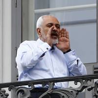 Iranian Foreign Minister Javad Zarif talks to journalists from the balcony of Palais Coburg in Vienna, the venue for nuclear the talks, on Monday. | REUTERS