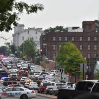 Police and emergency vehicles are seen near the scene of an unconfirmed shooting at the Navy Yard in Washington, D.C. on Thursday. | AFP-JIJI