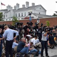 Members of the media gather outside the Navy Yard after a lockdown for an unconfirmed shooting on the premises Thursday. | AFP-JIJI