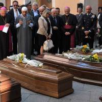 Ismail Bouchnafa (third left), vice president of the Sicilian Islamic Community, and Archbishop of Catania Salvatore Gristina (second left) attend the funeral of 13 migrants who were among up to 800 people who died in a shipwreck in April in Catania, Sicily, Italy, Tuesday. The 13 are the first victims of the shipwreck to be recovered by deep-sea operations being carried out by the Italian navy. | AP