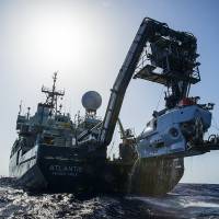 The research vessel Atlantis is shown off the coast of the Carolinas during the second week of July with the submersible Alvin hanging off its stern. The expedition led by Duke University marine scientist Cindy Van Dover has found a shipwreck that may date back to the late 1700s. Rare find a mile down off Carolina, shipwreck may date to late 1700s
