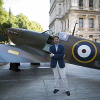 American entrepreneur and philanthropist Thomas Kaplan poses for photographs in front of his restored Vickers Supermarine Spitfire Mk.1A – P9374/G-MK1A World War II British fighter aircraft on display during a media event to promote the plane featuring in an auction by Christie\'s, outside the Cabinet War Rooms in London, on July 3. The aircraft, which gradually sank under the sands of Calais beach after it was shot down in 1940, was discovered in 1980, and currently owned by Kaplan. | AP