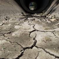 This picture taken on July 2, 2015 shows a dried out irrigation canal usually full of water this time of year, in Bang Pla Ma district, Suphanburi province, a two-hour drive north of Bangkok. | AFP-JIJI