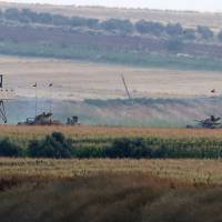 Turkish army tanks hold positions near the border with Syria, in the outskirts of the village of Elbeyi, east of the town of Kilis, in southeaster Turkey, Thursday. Suspected Islamic State militants fired at a Turkish military outpost from a region under its control, inside Syrian territory Thursday, killing a Turkish soldier and wounding two others, an official said. Turkish troops retaliated. | AP