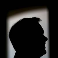 Republican presidential candidate Scott Walker listens as he is introduced to the crowd at a campaign stop in Cedar Falls, Iowa, on Sunday. | REUTERS