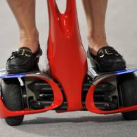 The wheels of a Winglet mobility device manufactured by Toyota Motor Corp. are seen during a demonstration in Tokyo on Aug. 1, 2008. | BLOOMBERG