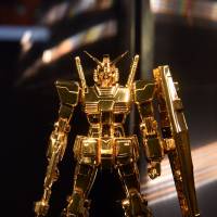 Jeweler Tanaka Kikinzoku Jewelry unveiled a pure gold robot figure Gundam, worth &#165;20 million, at a press preview Thursday of \"The Art of Gundam\" exhibition at Mori Arts Center Gallery in Roppongi, Tokyo. | AFP-JIJI