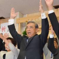 Gunma Gov. Masaaki Osawa celebrates his re-election Sunday at his office in Maebashi. | KYODO