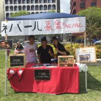 Bilam Karki (center) and friends operate a booth during one of his fundraising events at the Beppu Kitahama Golden Week Carnival on May 4. | COURTESY OF BILAM KARKI