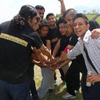 Nepalese students at Ritsumeikan Asia Pacific University show their spirit before a charity cricket match against the university\'s team on May 17. | COURTESY OF BILAM KARKI