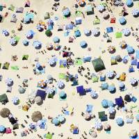An aerial photo shows beach umbrellas and tents adorning Shirarahama Beach in Wakayama Prefecture on July 20. The weather agency declared an end to the rainy season throughout the archipelago on Wednesday. | KYODO