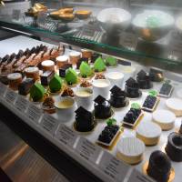 The lineup: Cakes and sweets in rows under the counter. | J.J. O\'DONOGHUE